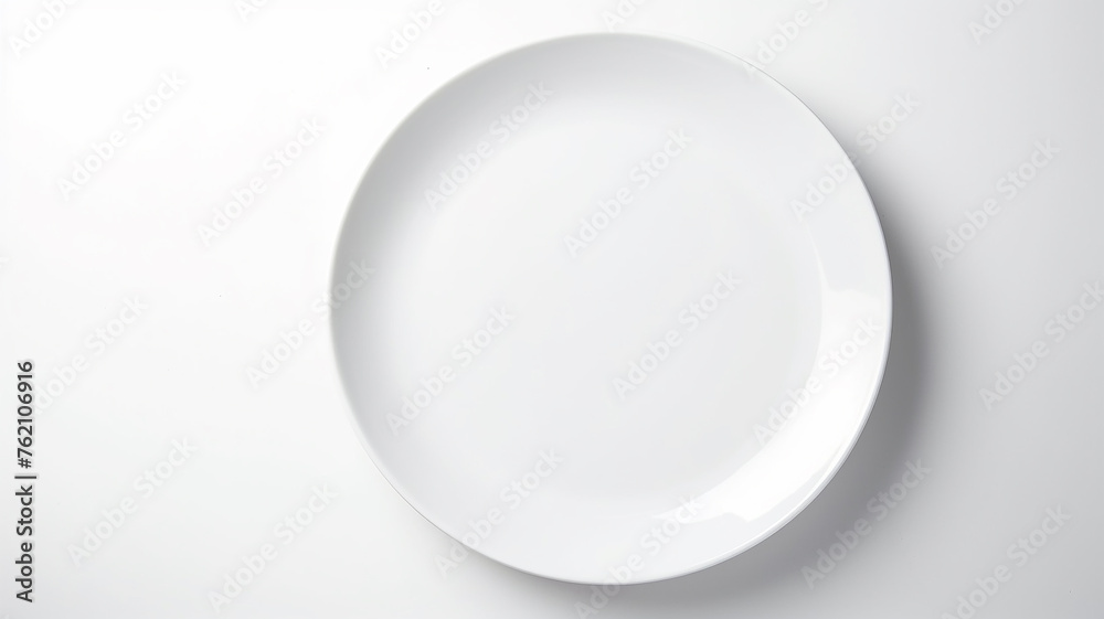 A white empty round plate on a white background, an image with copy space A white empty round plate on a white background, an image with copy space