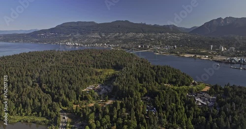 Vancouver BC Canada Aerial v85 flyover Stanley park capturing urban oasis, Lions gate bridge, industrial zone on North shore, harbour and mountain views - Shot with Mavic 3 Pro Cine - July 2023 photo