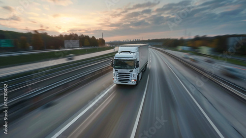 Trucks driving on the highway winding through forested landscape