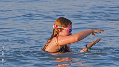 Young Caucasian Girl Playing in Neck Deep Sea Water © rohawk
