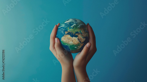 Hands cradle a globe with tender care, symbolizing environmental stewardship.