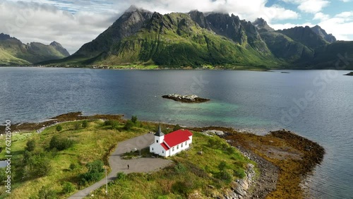 Austnesfjord , Lofoten, Norway white church with red roof in fjord with mountain landscape. photo