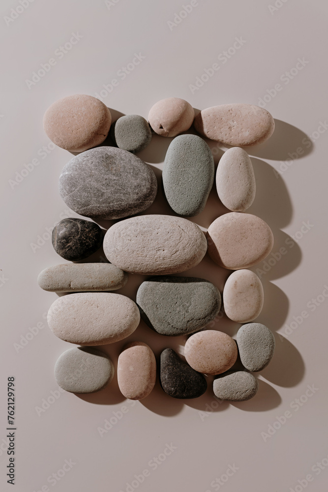 Square made of pebble stones on white background with warm white light Square made of pebble stones on white background with warm white light
