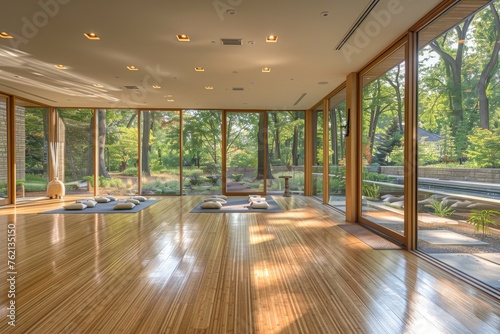 A large room with wooden floors and lots of windows