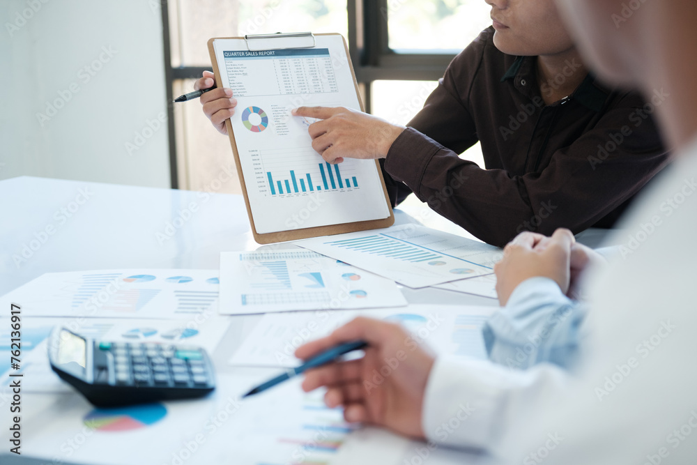 A team of business people is brainstorming to analyze investment project data. A team of business people is brainstorming to analyze investment project data.