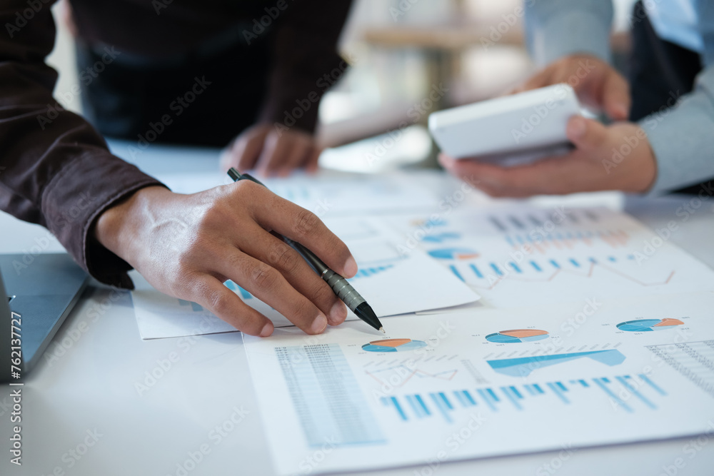 A team of business people is brainstorming to analyze investment project data. A team of business people is brainstorming to analyze investment project data.