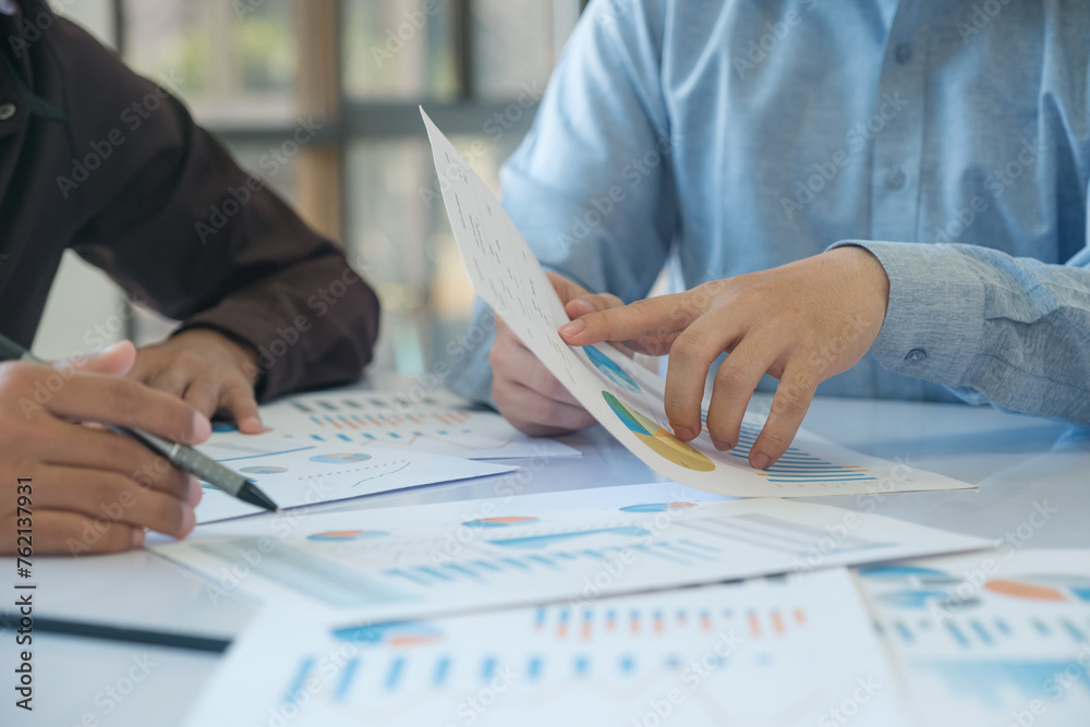 A team of business people is brainstorming to analyze investment project data.