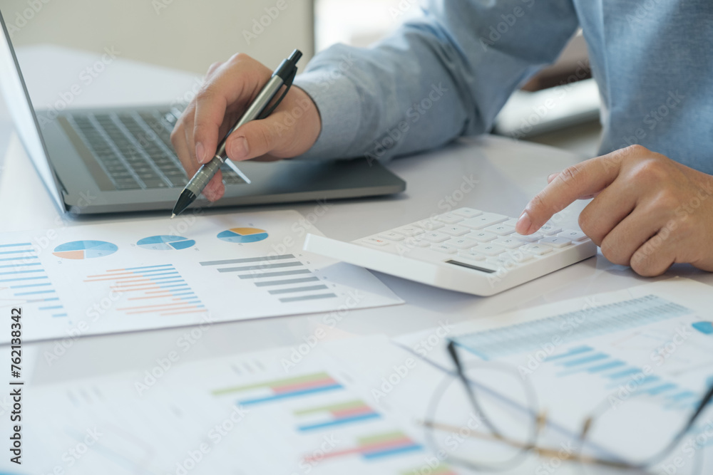 Accountants are using calculators to calculate income, expenses, and investments. Accountants are using calculators to calculate income, expenses, and investments.