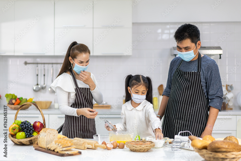 Portrait of enjoy happy love asian family father and mother with little asian girl daughter child play and having fun cooking food together with baking cookie and cake ingredient in kitchen Portrait of enjoy happy love asian family father and mother with little asian girl daughter child play and having fun cooking food together with baking cookie and cake ingredient in kitchen