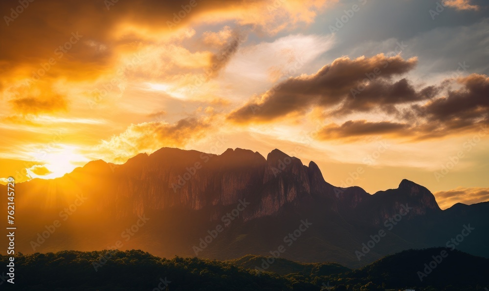 silhouette of high mountains golden colors of sunset