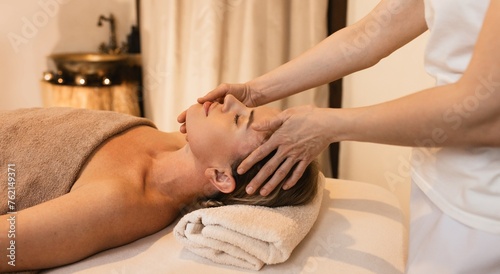 Head massage therapy. Adult woman enjoying head massage at wellness spa for anti-stress treatment