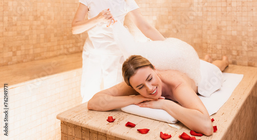 Hammam female client enjoying foam massage in Turkish bath. Procedures in oriental bath improves skin and stops aging process