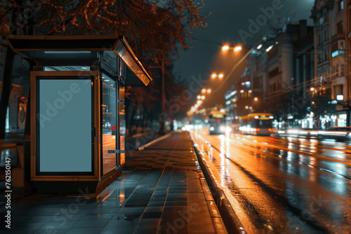 Blank bus stop advertising billboard in the city at night.