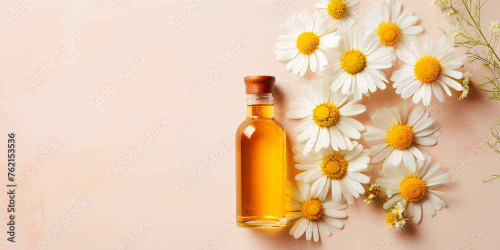 Flat lay, chamomile essential oil bottle with space for text Flat lay, chamomile essential oil bottle with space for text