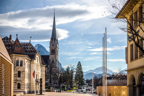 Alpine Charm  Liechtenstein Cityscape with Majestic Mountain Backdrop and Church Spire
