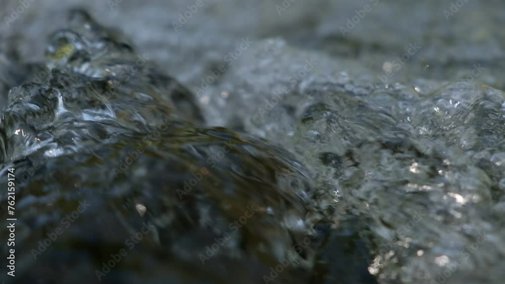 Blurred on backgroud.On top water flows in a stream where air bubbles form. Blurred on backgroud.On top water flows in a stream where air bubbles form.