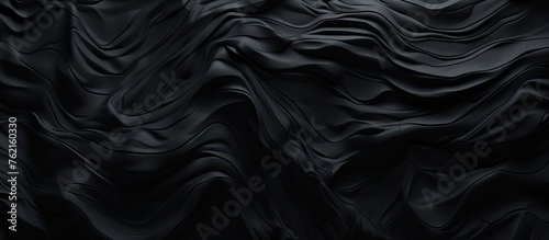 A detailed macro shot of a black marble texture set against a dark background, creating a monochrome aesthetic reminiscent of sleek automotive tire patterns