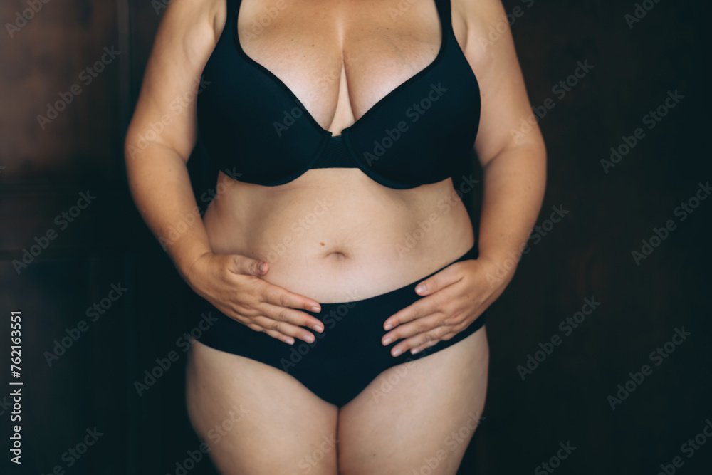 A front-view image of a woman in black lingerie, embodying body positivity and self-acceptance, promoting diversity and confidence.