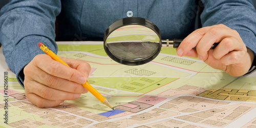 Buildings Permit concept with imaginary cadastral map and General Urban Plan - Building activity and construction industry concept with magnifying glass
