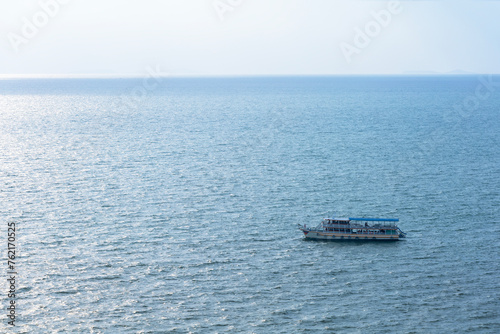 Fototapeta Naklejka Na Ścianę i Meble -  A cruise ship with people tourists in the sea. Boat trip ship tour tourists people.