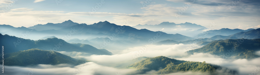 Awe-Inspiring View of Majestic Peaks and Verdant Valleys Blanketed in Mist and Clouds, with Lush Green Slopes Adding to the Serenity, Inviting Viewers to Explore Nature's Grandeur and Tranquility