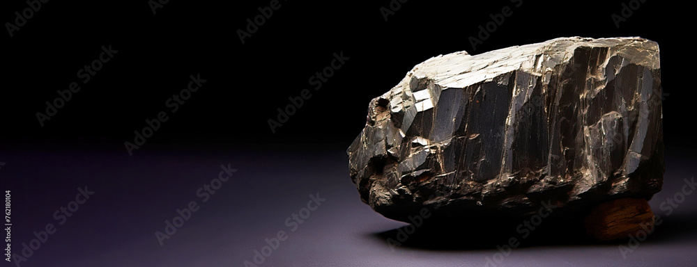 Aenigmatite is a rare precious natural stone on a black background. AI generated. Header banner mockup with space.