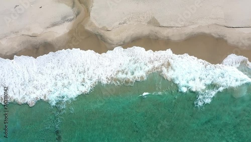 Beautiful blue ocean wave on fine sandy beach.
Dorone flight over the sea. photo