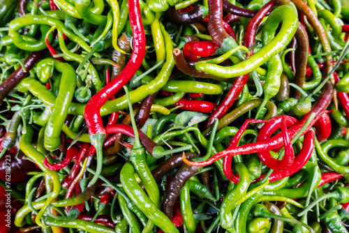 Hot chili pepper harvest, red and green long capsicum pepper heap, top view, hot spice cooking ingredient © bermuda cat