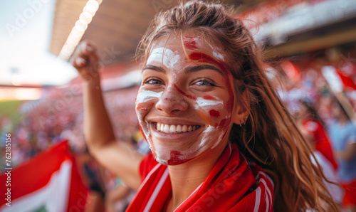 Portrait of a passionate female Denmark fan celebrating at a UEFA EURO 2024 football match, her face painted with the colors and patterns of the Denmark flag, radiating enthusiasm and national pride