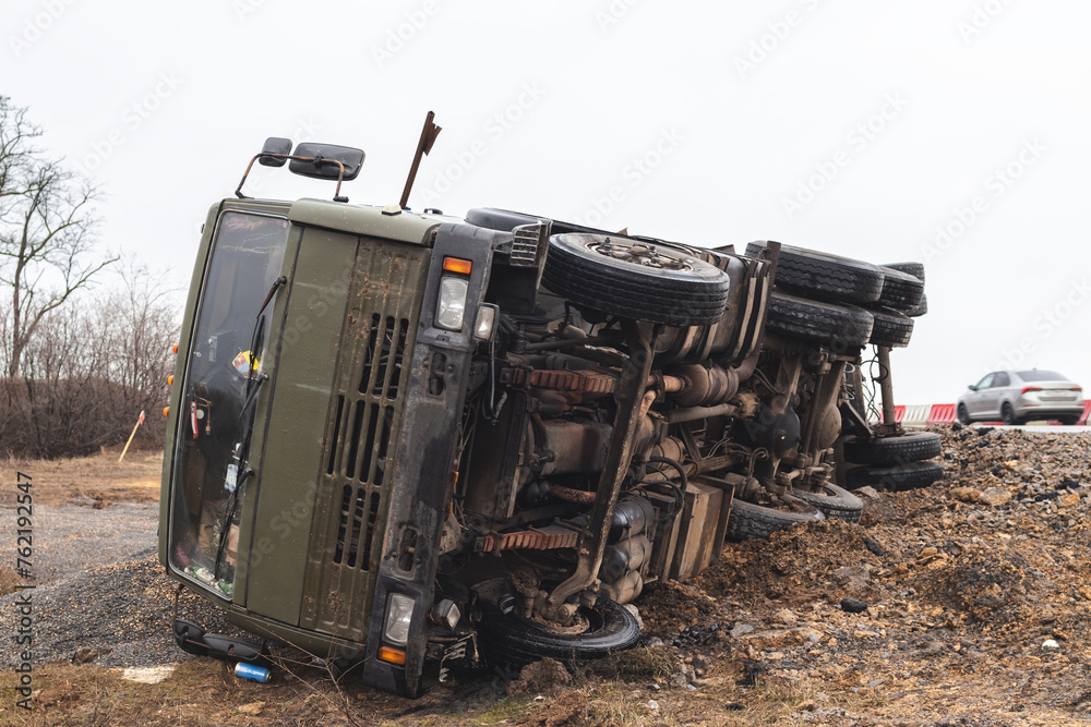 The large truck lies in a side ditch after the road accident