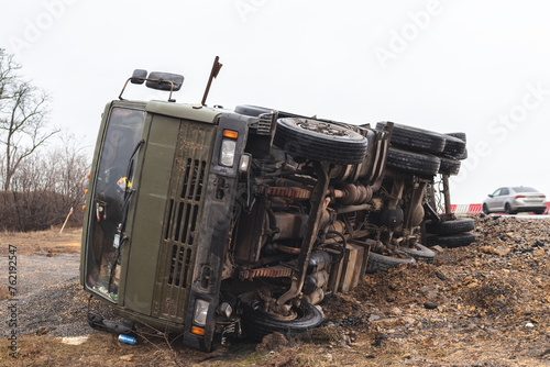 The large truck lies in a side ditch after the road accident