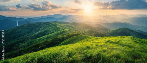 Majestic sunrise over verdant mountain ridges with wind turbines, a vision of green energy photo