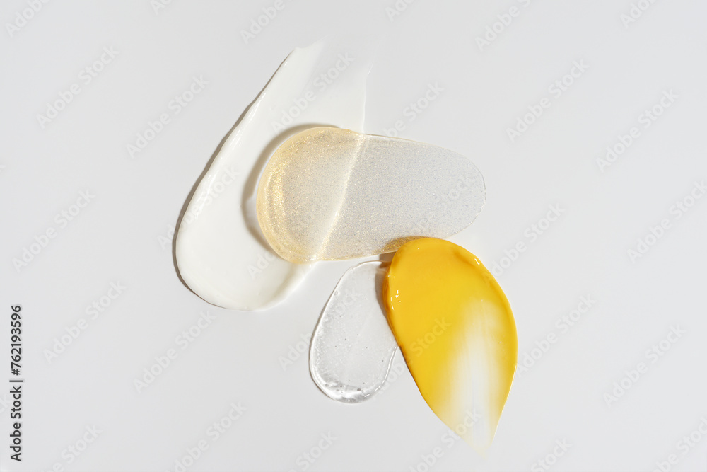 Cosmetic smears of creamy texture on a beige grey background Cosmetic smears of creamy texture on a beige grey background