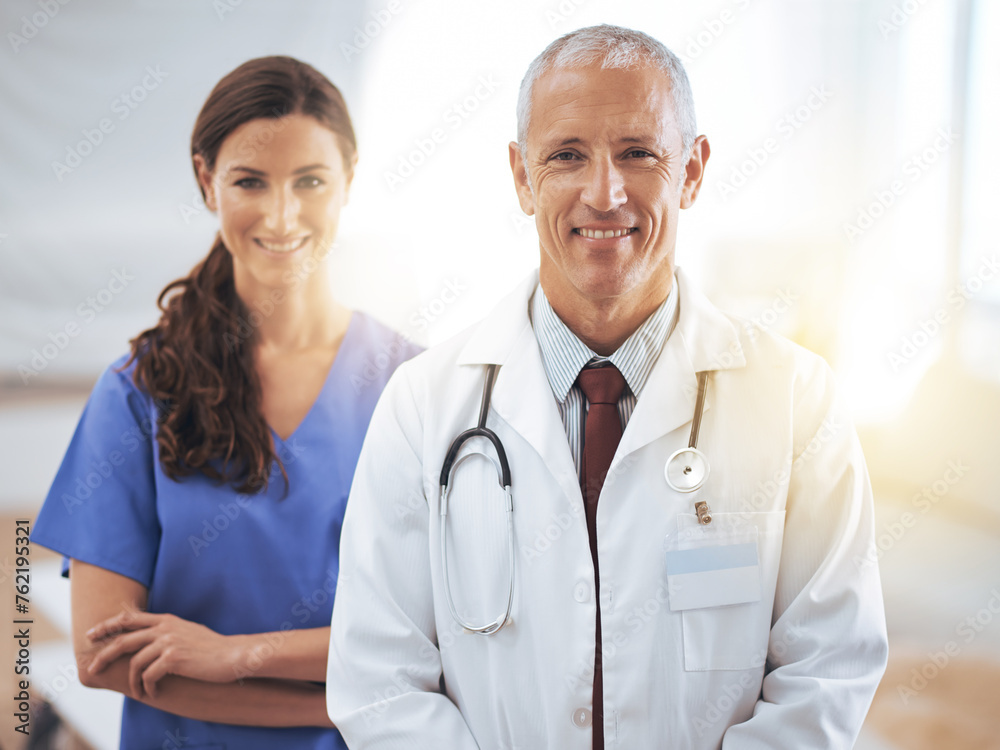 Doctors, man and woman in portrait at hospital for medical support, wellness and arms crossed with smile. Medic, surgeon and nurse in team, happy and health services in clinic with pride for career Doctors, man and woman in portrait at hospital for medical support, wellness and arms crossed with smile. Medic, surgeon and nurse in team, happy and health services in clinic with pride for career