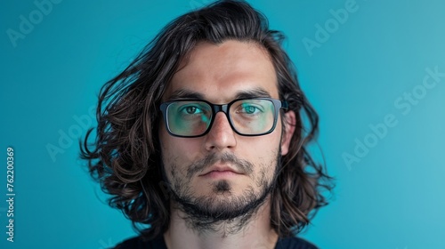 Portrait of a handsome man with glasses and long hair