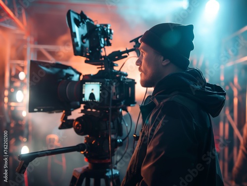 Professional cinematographer operating a camera on a dynamic movie set with atmospheric lighting.