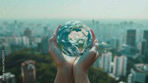 hands holding Globe Glass earth globe earth day World environment day concept, Forest green and city background, 