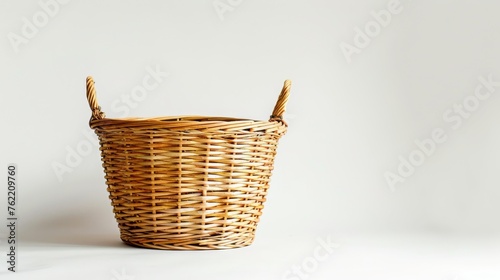 A solitary wicker basket, showcased in isolation against a stark white background