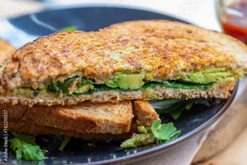 Delicous vegetarian sandwich with fresh ingredients and avocado. 