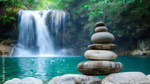 A Zen-like balance of rocks, positioned in front of a cascading waterfall, creating a serene and meditative atmosphere