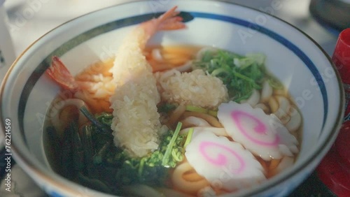 Japanese noodle or Udon with deep fried shrimp or tempura on table photo