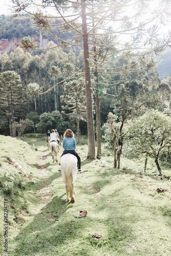 couple ride horses in the park