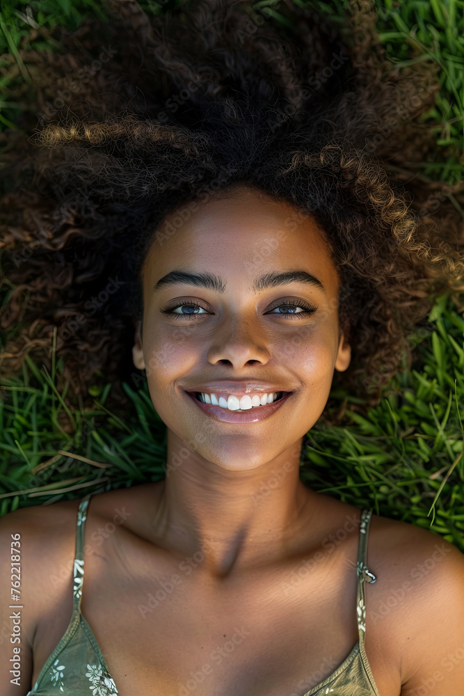 A beautiful model lying on a grass field A beautiful model lying on a grass field