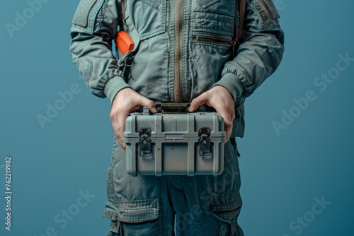 Close-up view of an Air Force engineer in uniform holding a toolbox photo