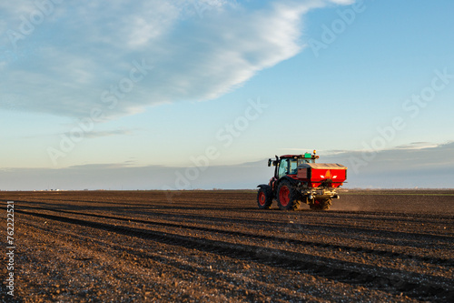 Tractor spreading artificial fertilizers