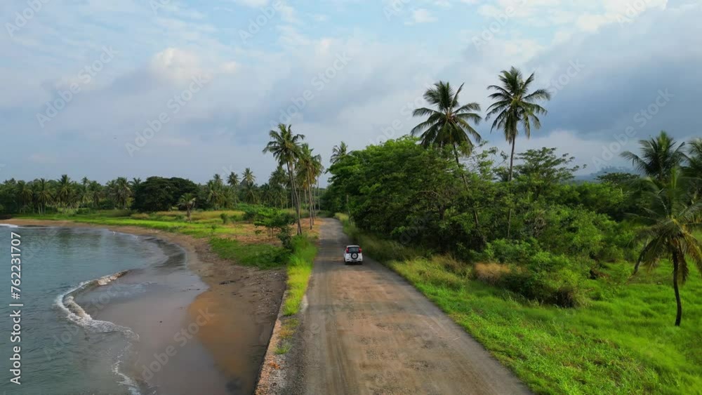 Following a car on the coast surrounded by a magnificent green landscape at Sao Tome e Principe,Africa. Following a car on the coast surrounded by a magnificent green landscape at Sao Tome e Principe,Africa.
