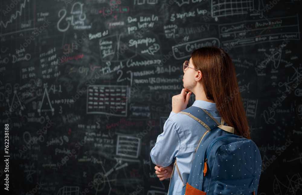 Teenager in class on background of blackboard Teenager in class on background of blackboard