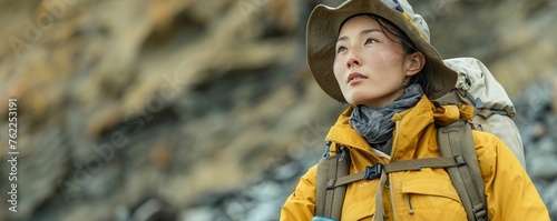 A female archaeologist of Asian descent, mid-30s, wearing rugged exploration gear photo