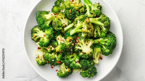 Steamed broccoli florets on a white plate.