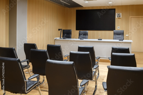 modern office meeting room interior with large monitor and leather chairs